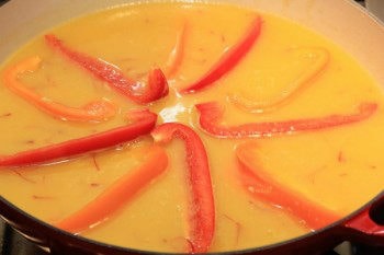 bell pepper placed inside liquid in a metal pan
