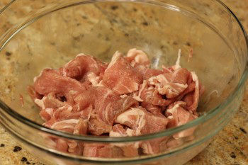 ingredients for teriyaki pork bowl inside a glass bowl on counter top