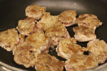 teriyaki pork balls cooking in a frying pan