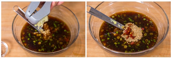 minced garlic, sesame seeds, and chopped red chili pepper in a glass bowl on wood cutting board