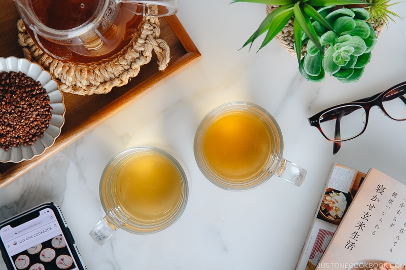 Hot buckwheat tea (sobacha) served in a glass cup.
