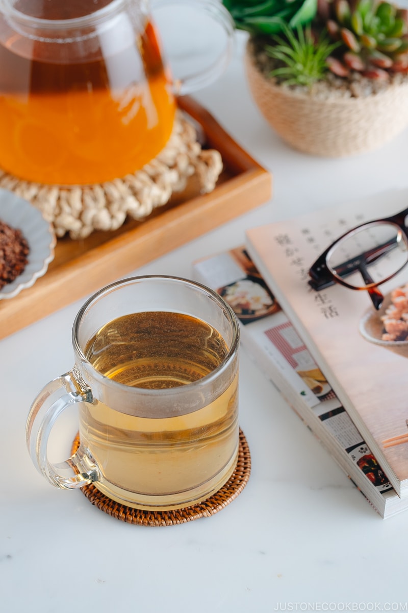 Hot buckwheat tea (sobacha) served in a glass cup.