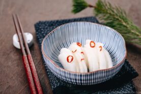 Japanese Pickled Daikon in a Japanese blue ceramic bowl.