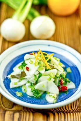 Pickled Turnip with Yuzu on a blue plate.