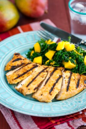 Grilled miso chicken served with Mango Kale Salad on a light blue plate.