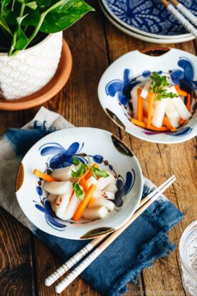 Daikon and carrot pickled in sweet vinegar, served in Japanese ceramic bowls.
