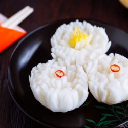 A black lacquered plate containing Pickled Chrysanthemum Turnip (Kikka Kabu).