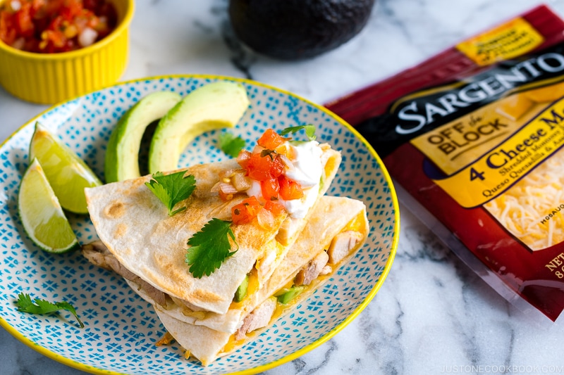 A plate containing teriyaki chicken quesadilla.