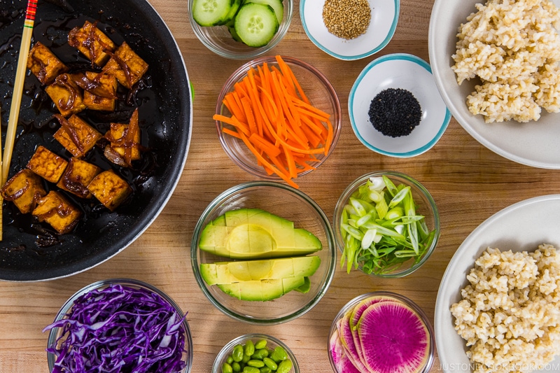 Assembling Vegan Poke Bowls.