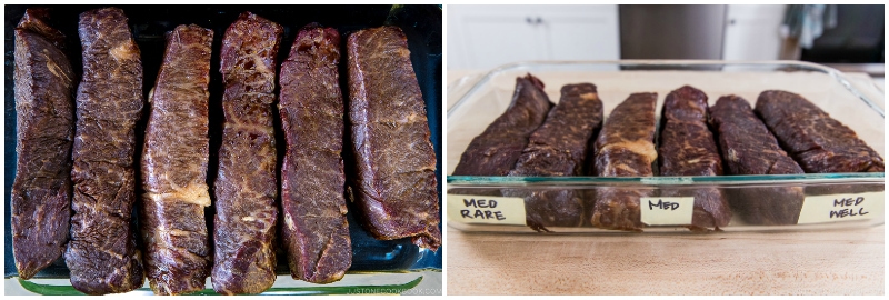 Steak finished cooking in a glass tray with label for doneness