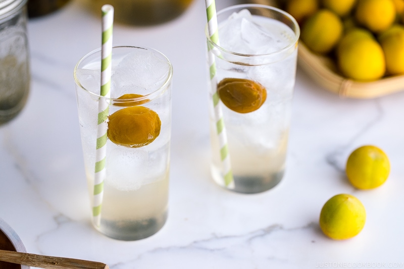 Tall glasses containing ume syrup cider and ume compote.