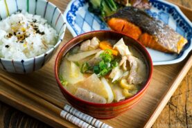 Tonjiru (Pork and Vegetable Soup) served with grilled salmon, steamed rice, and vegetable side dishes.