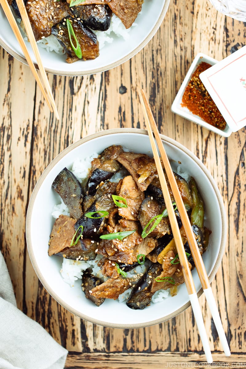 A bowl containing Miso Pork and Eggplant Stir-Fry over steamed rice.