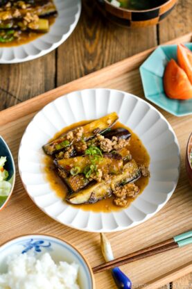 A white plate containing Mapo Eggplant (Mabo Nasu).