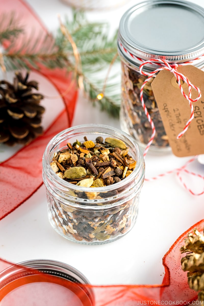 A mason jar containing Mulling Spices for Hot Mulled Cider.