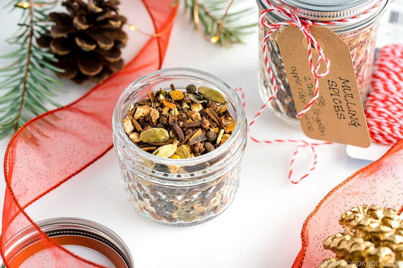 A mason jar containing Mulling Spices for Hot Mulled Cider.