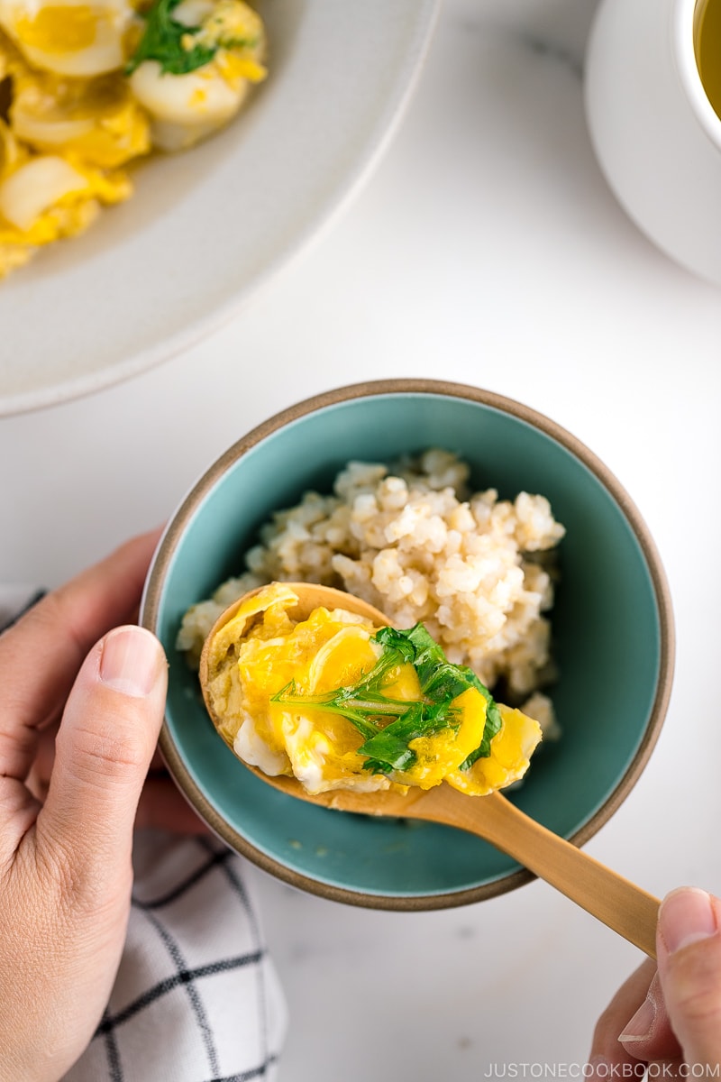 A ceramic dish containing lily bulb tamagotoji over steamed brown rice.