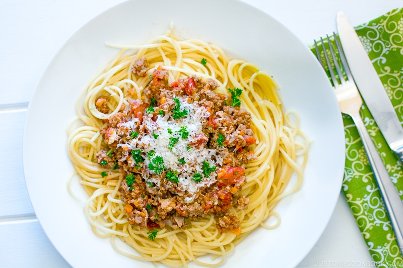 A white plate containing Spaghetti Meat Sauce.