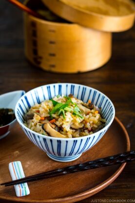 A Japanese blue and white rice bowl containing Takikomi Gohan (Mixed Rice).