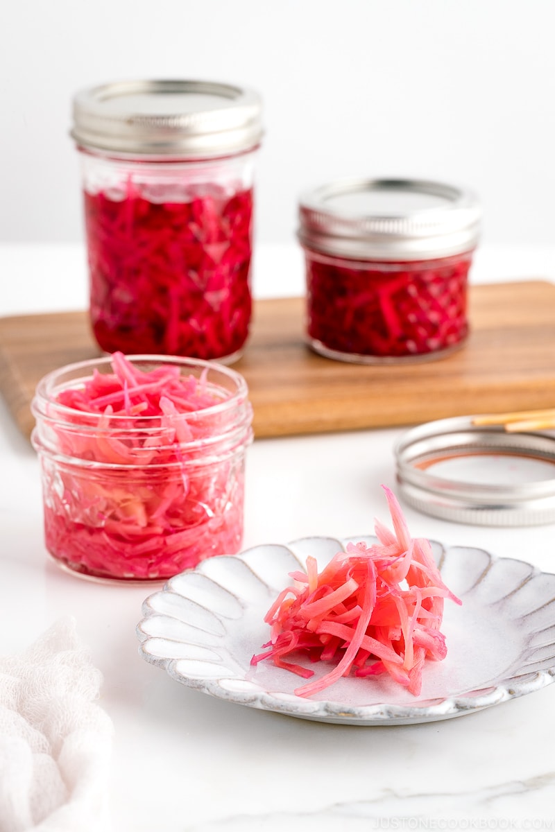 Mason jars containing beni shoga (Japanese red pickled ginger).