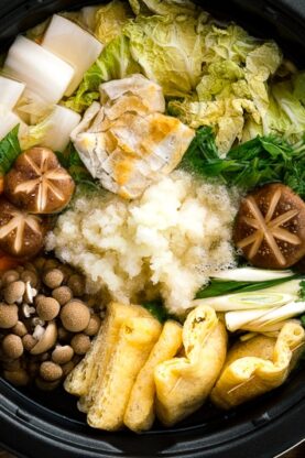 An electric hot pot containing Mizore Nabe, a Japanese hot pot with grated daikon.