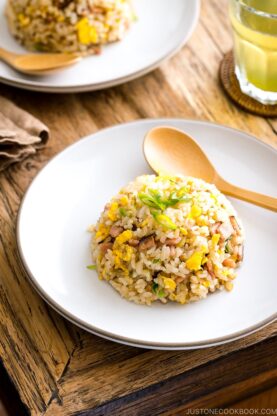 A white ceramic plate containing Japanese fried rice (Yakimeshi).