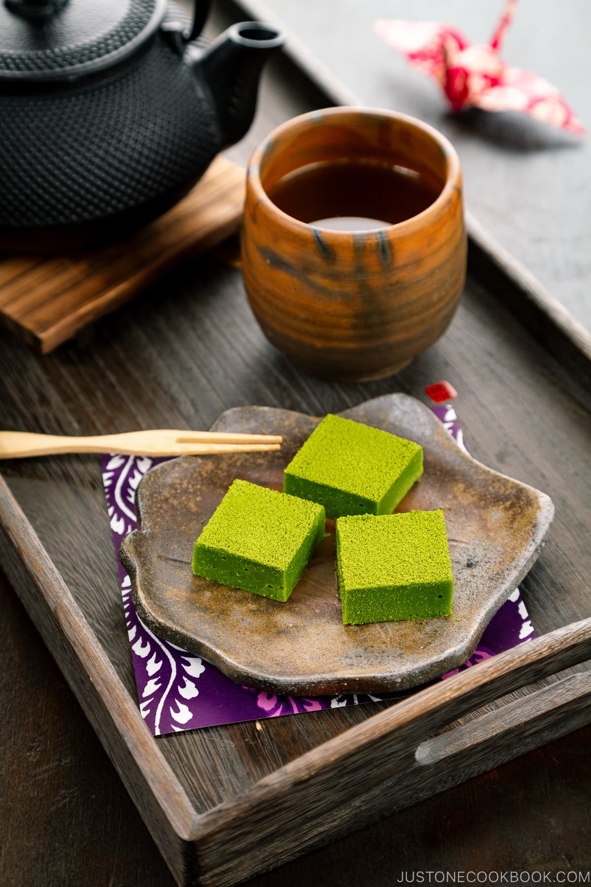 A Japanese plate containing matcha chocolate.