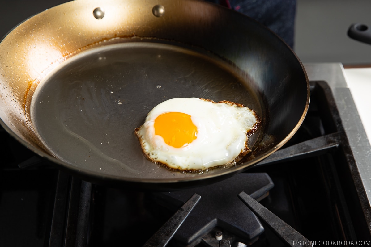 egg sliding on fry pan