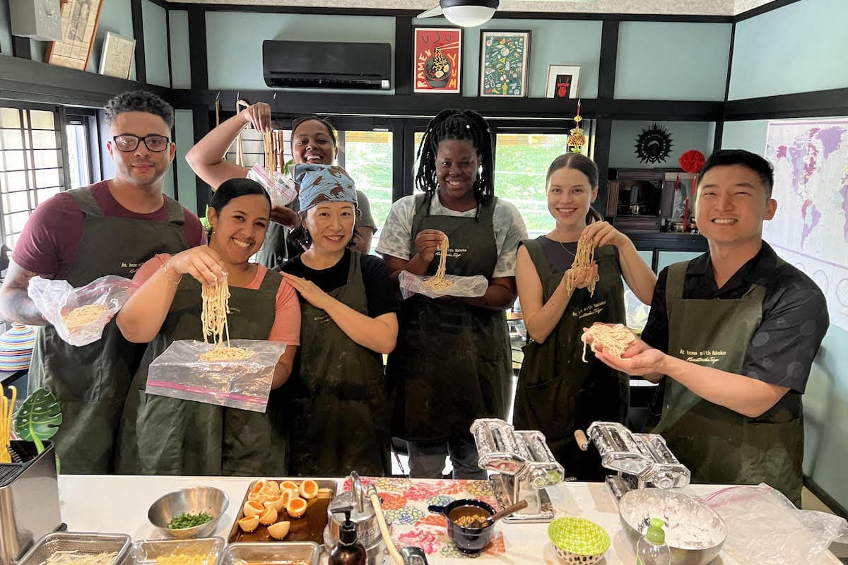 Students posing with their handmade ramen in a cooking class in Tokyo