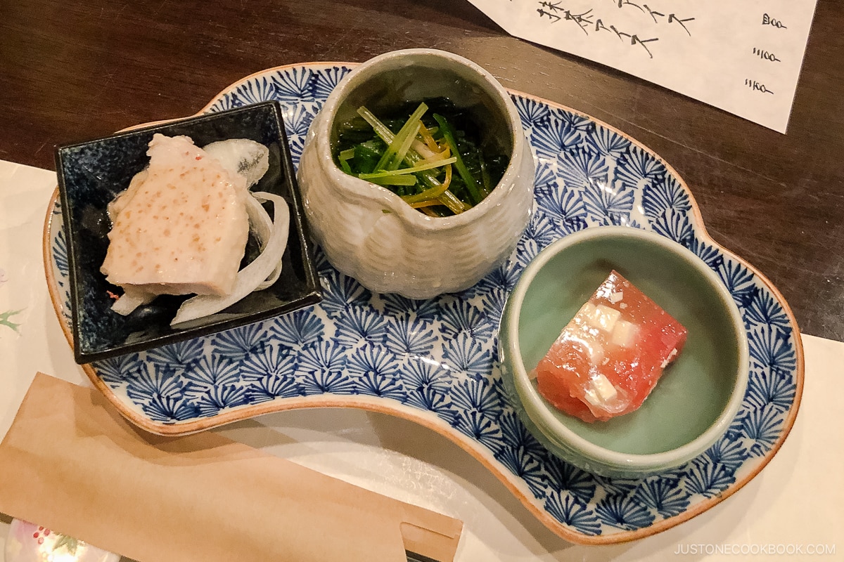 three small dishes on a blue dish