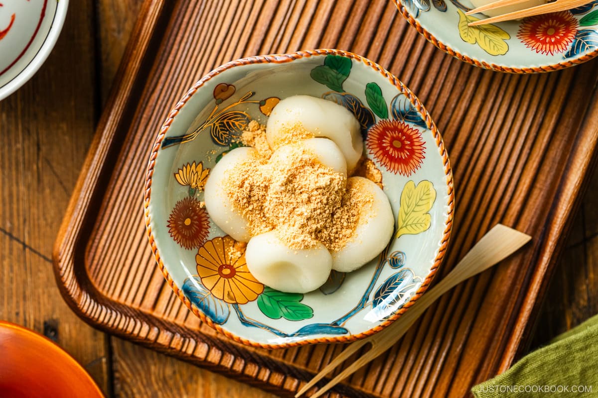 Japanese bowls containing shiratama dango dusted with sweetened kinako (soybean flour) on top.