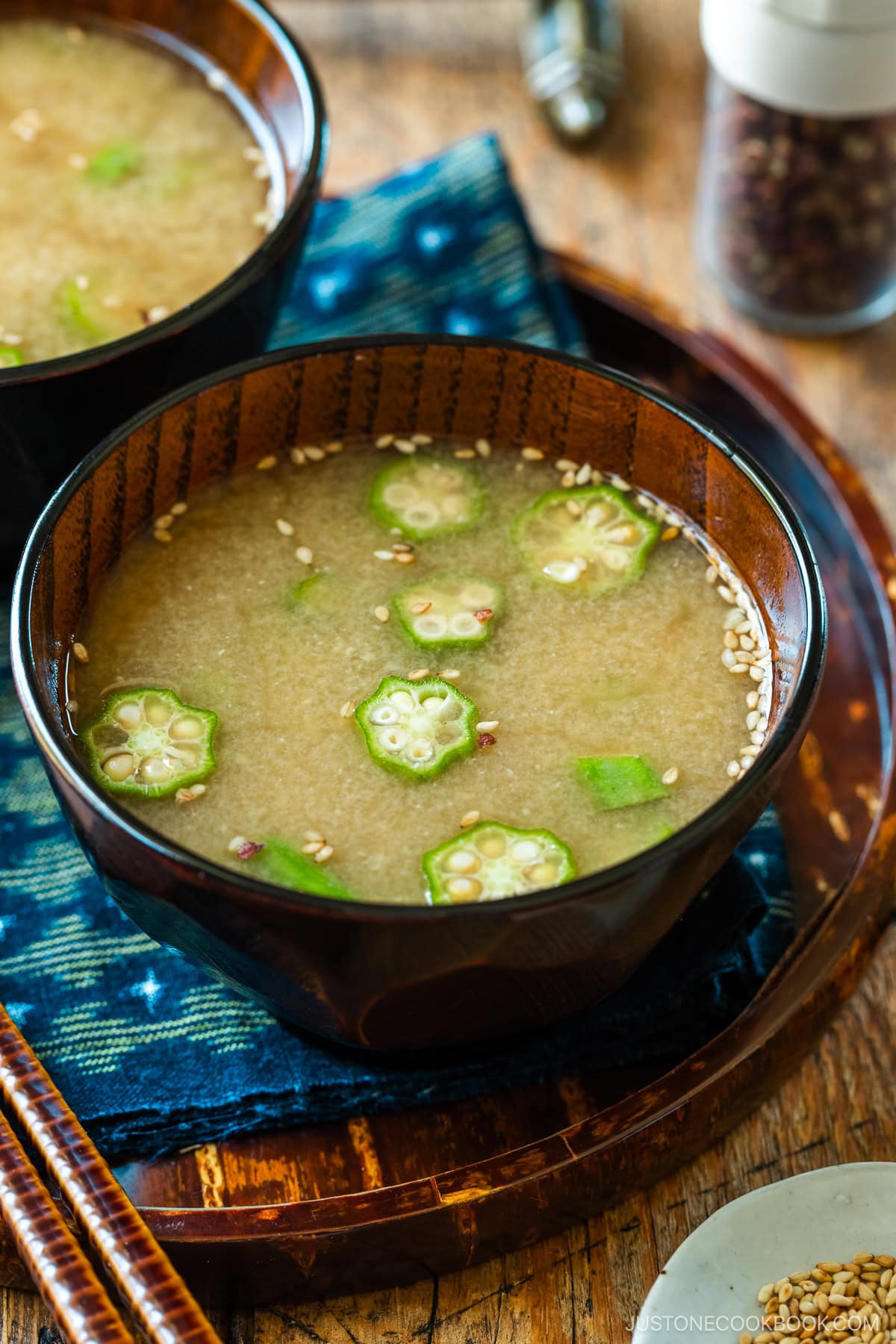 Miso soup bowls containing Natto and Okra Miso Soup topped with sesame seeds.