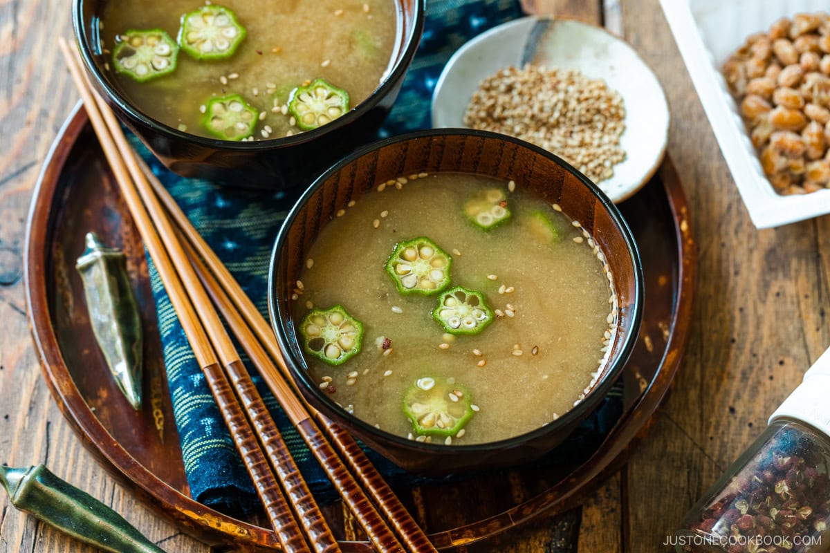 Miso soup bowls containing Natto and Okra Miso Soup topped with sesame seeds.
