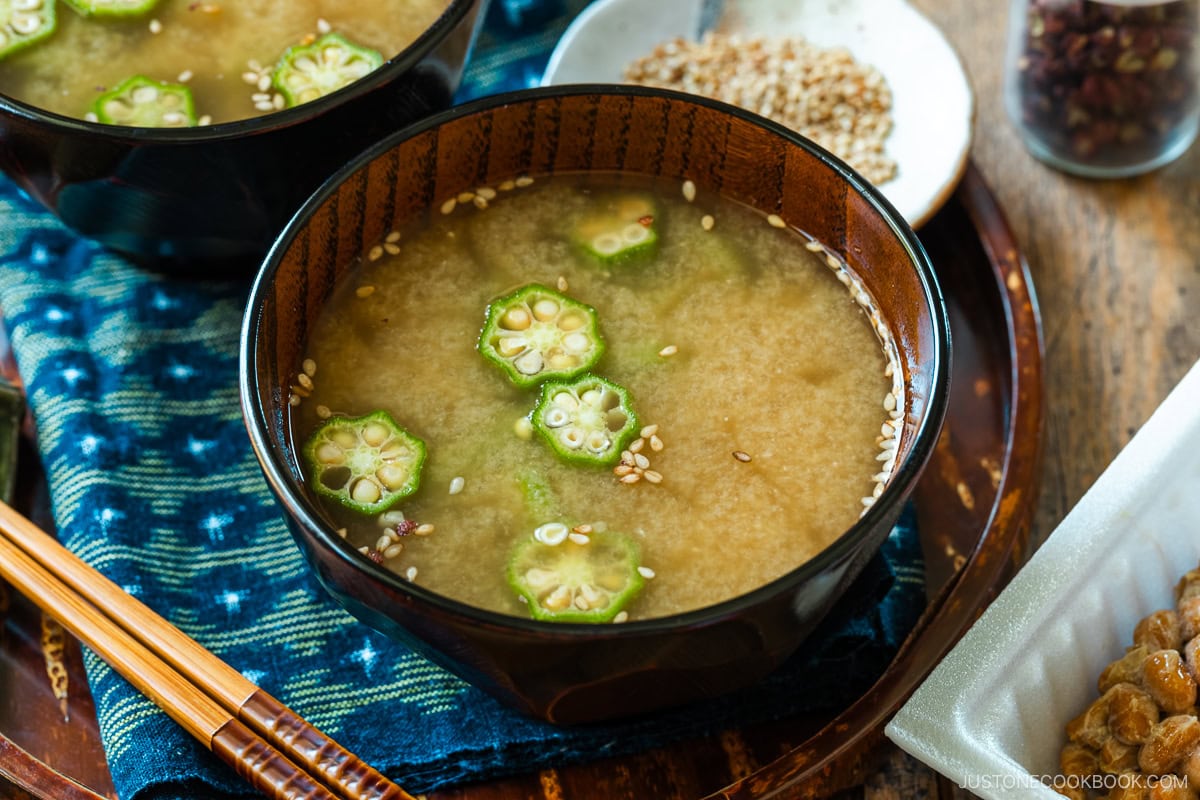 Miso soup bowls containing Natto and Okra Miso Soup topped with sesame seeds.