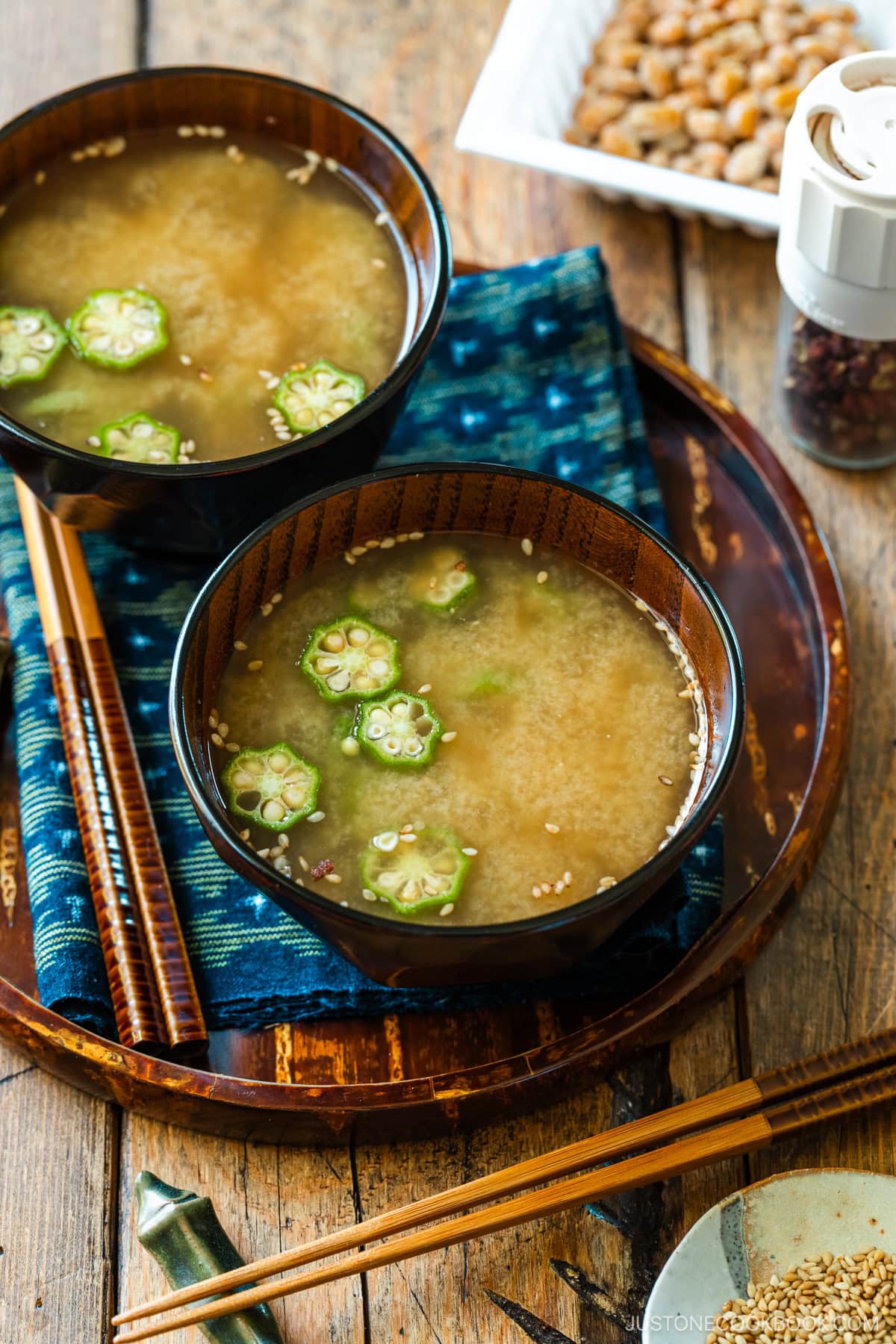 Miso soup bowls containing Natto and Okra Miso Soup topped with sesame seeds.