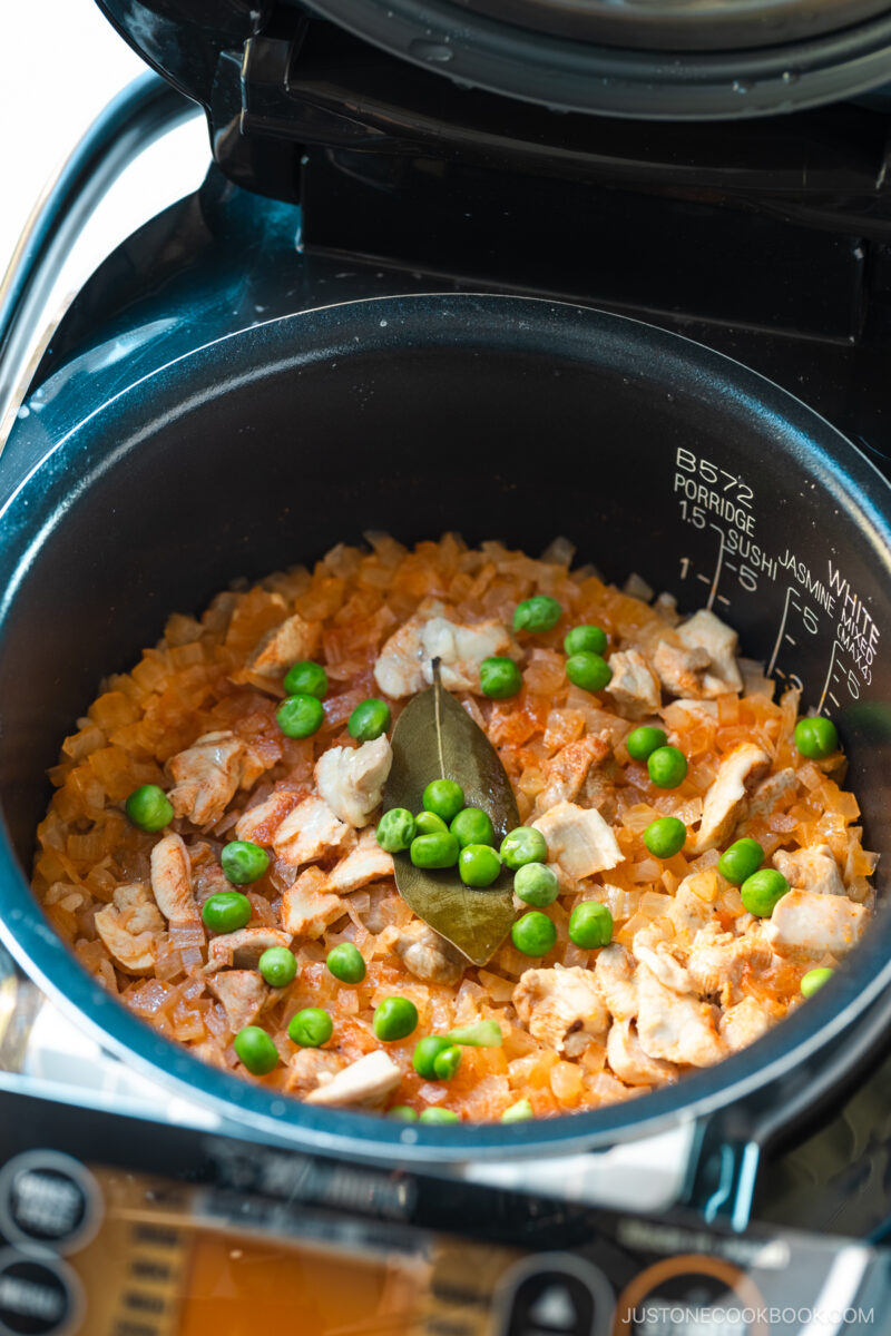 A rice cooker containing Chicken Rice, seasoned with Japanese ketchup and Worcestershire sauce.