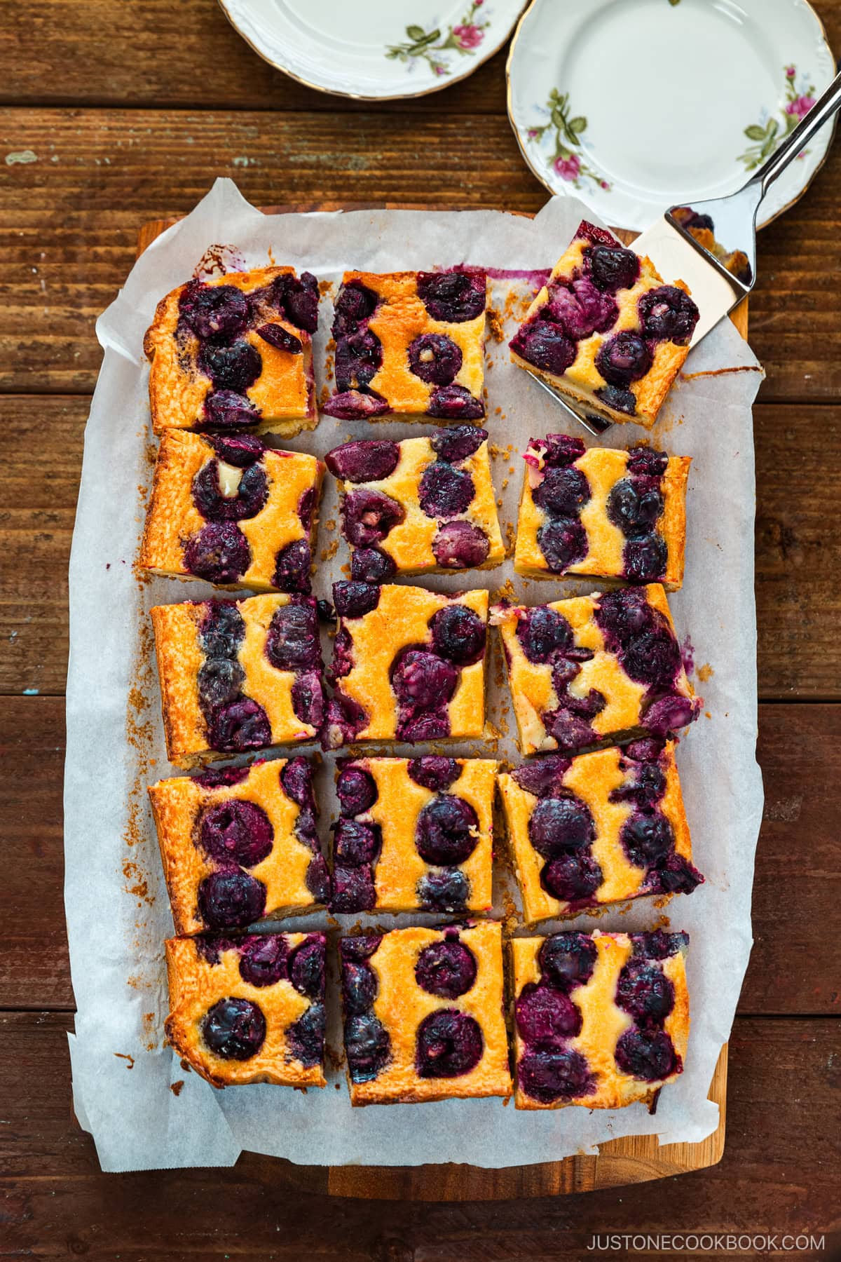 Cherry bards on top of a wooden cutting board.