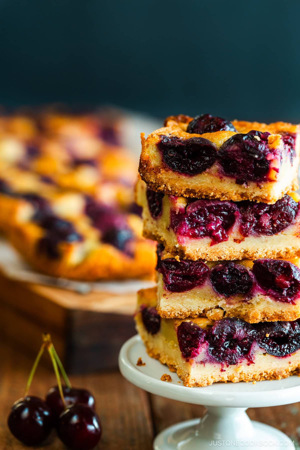 Cherry bards on top of a wooden cutting board.