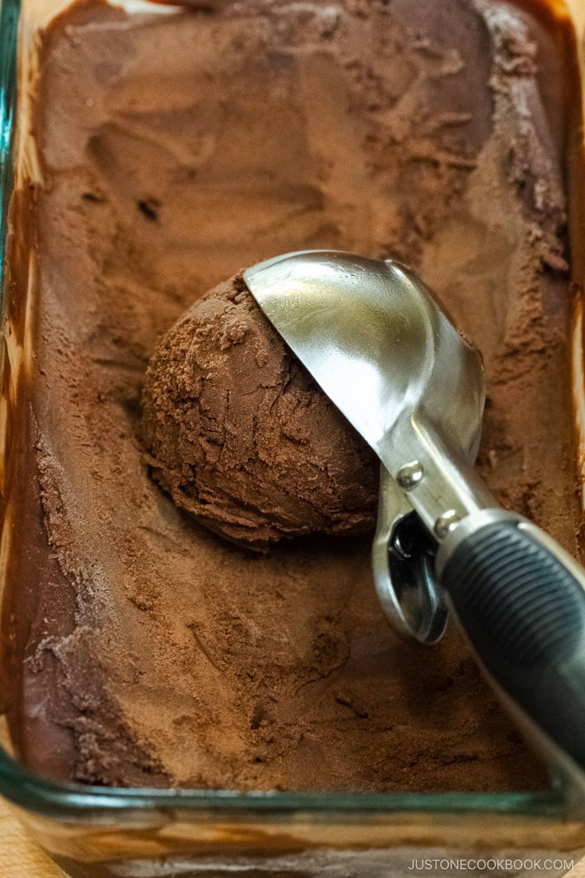 Rich chocolate ice cream in a glass container.