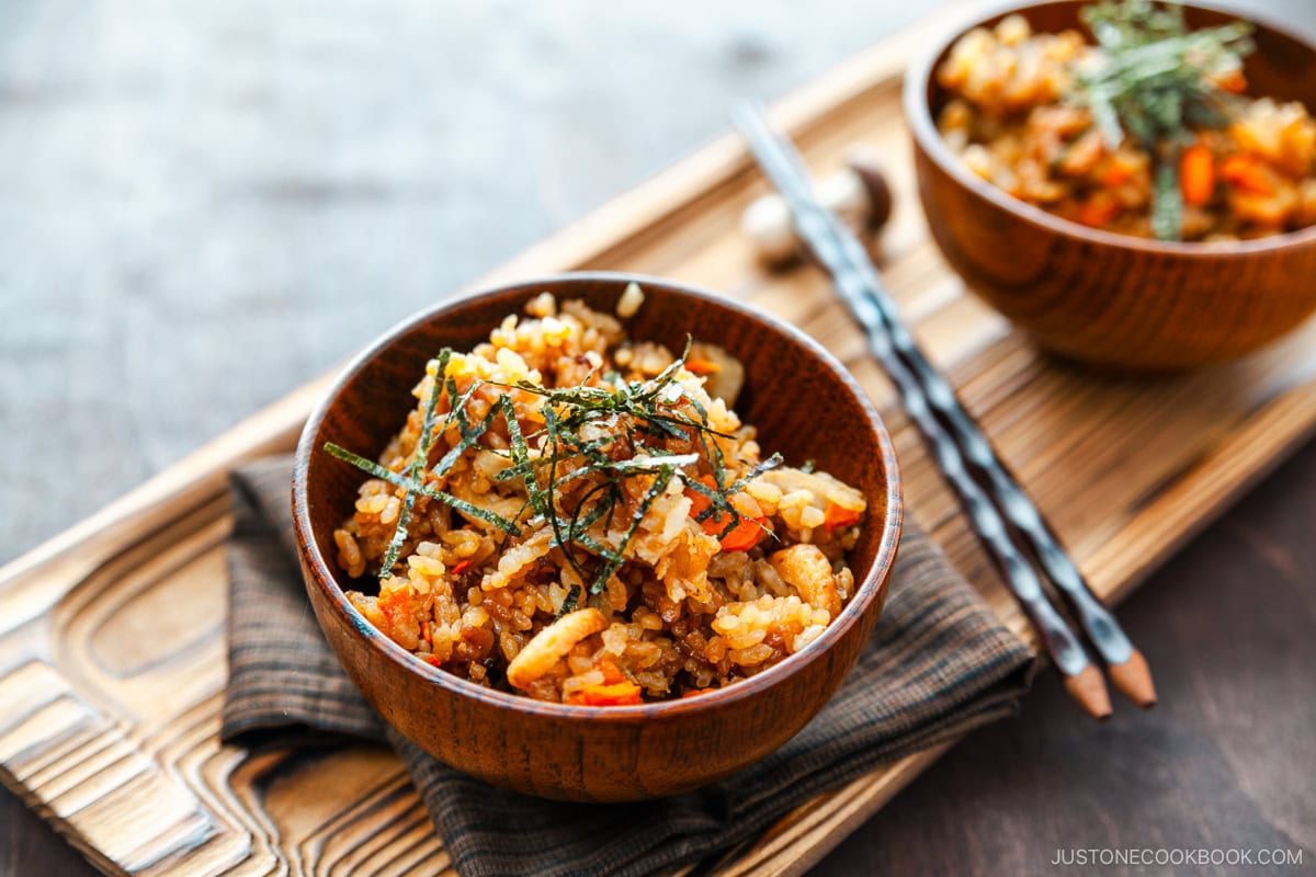 Wooden rice bowls containing gobo and miso takikomi gohan or Japanese mixed rice dish withburdock root and carrots seasoned with miso.
