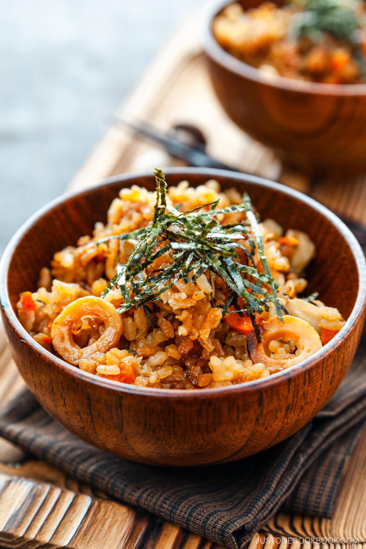 Wooden rice bowls containing gobo and miso takikomi gohan or Japanese mixed rice dish withburdock root and carrots seasoned with miso.