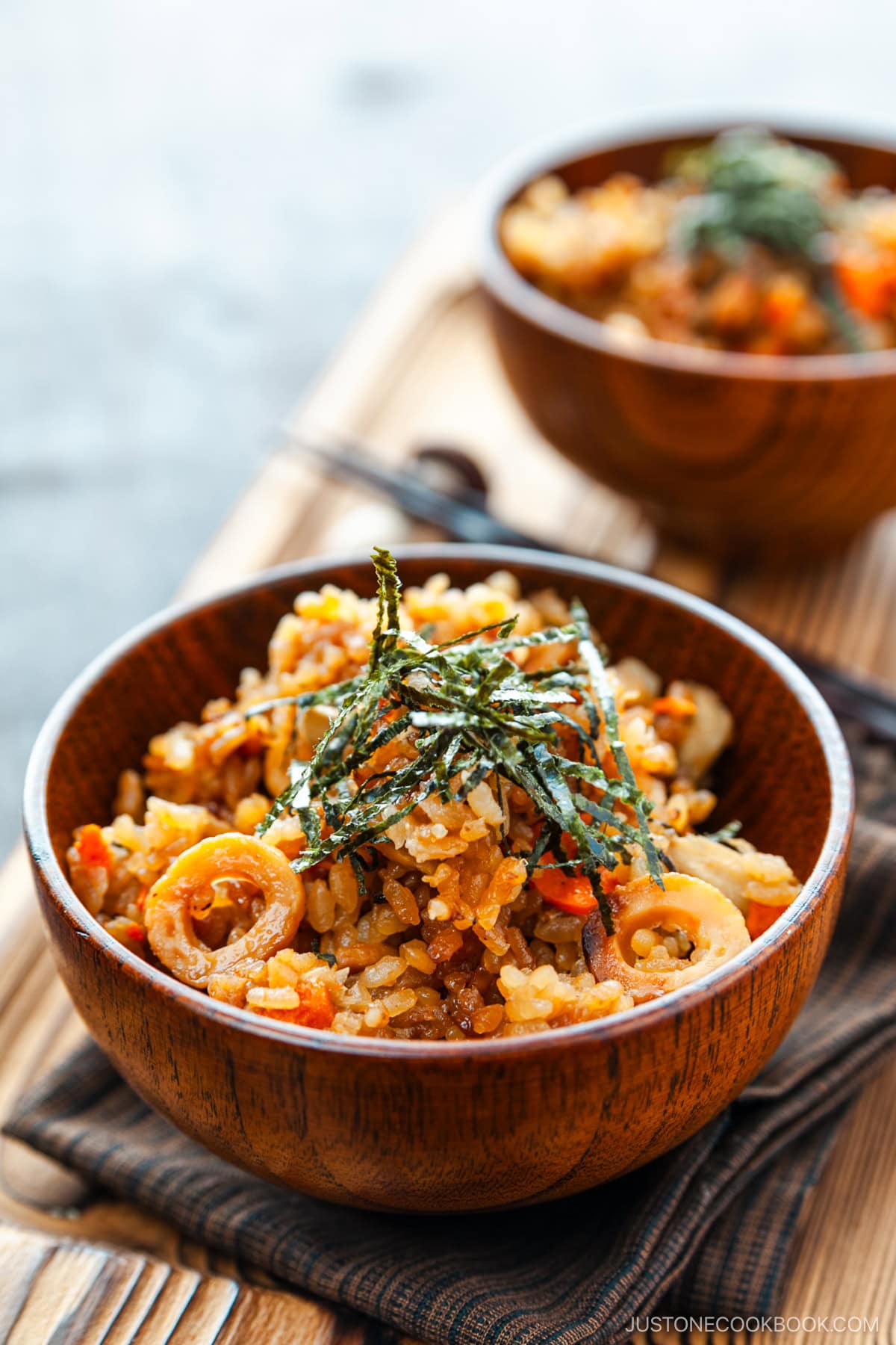 Wooden rice bowls containing gobo and miso takikomi gohan or Japanese mixed rice dish withburdock root and carrots seasoned with miso.