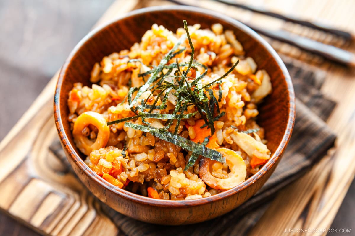 Wooden rice bowls containing gobo and miso takikomi gohan or Japanese mixed rice dish withburdock root and carrots seasoned with miso.