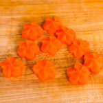 Carrot coins carved into Japanese ume plum shapes.