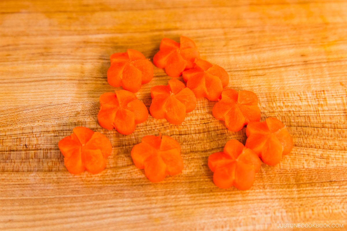 Carrot coins carved into Japanese ume plum shapes.