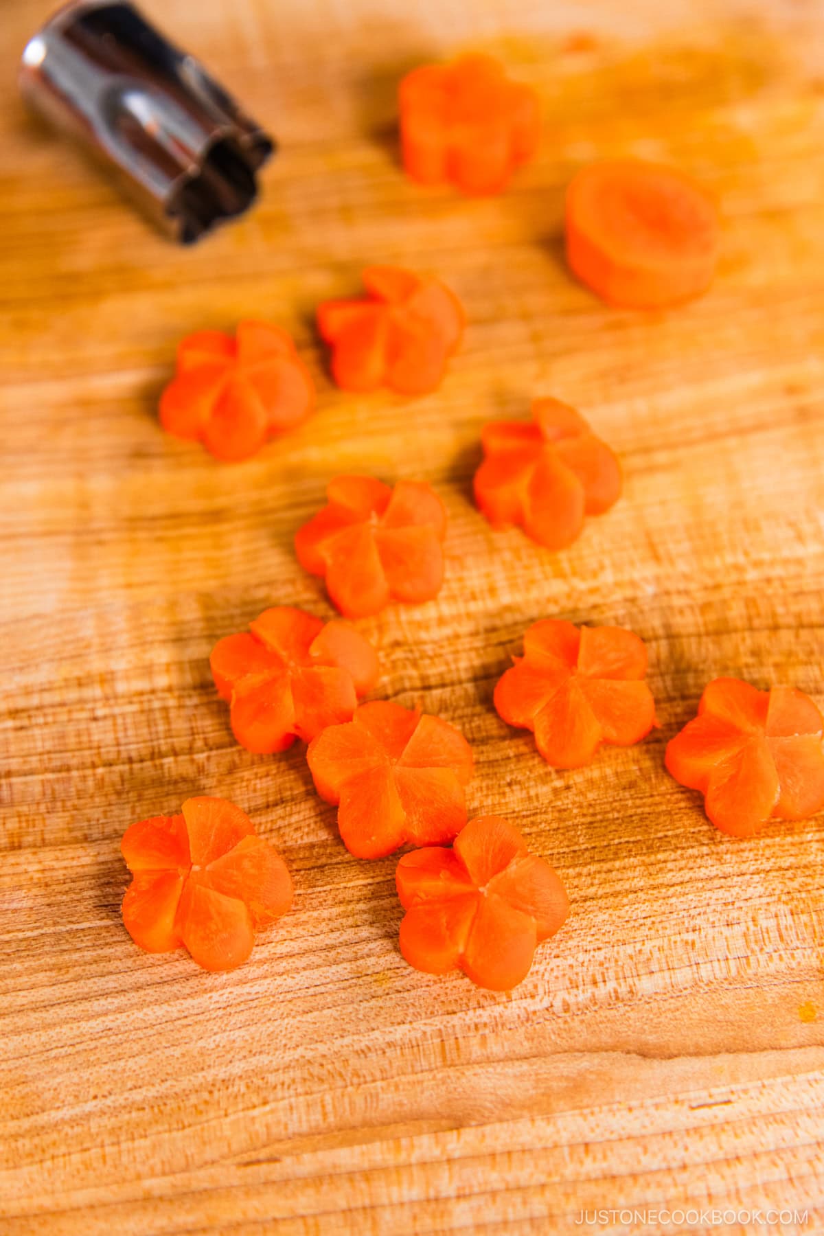 Carrot coins carved into Japanese ume plum shapes.