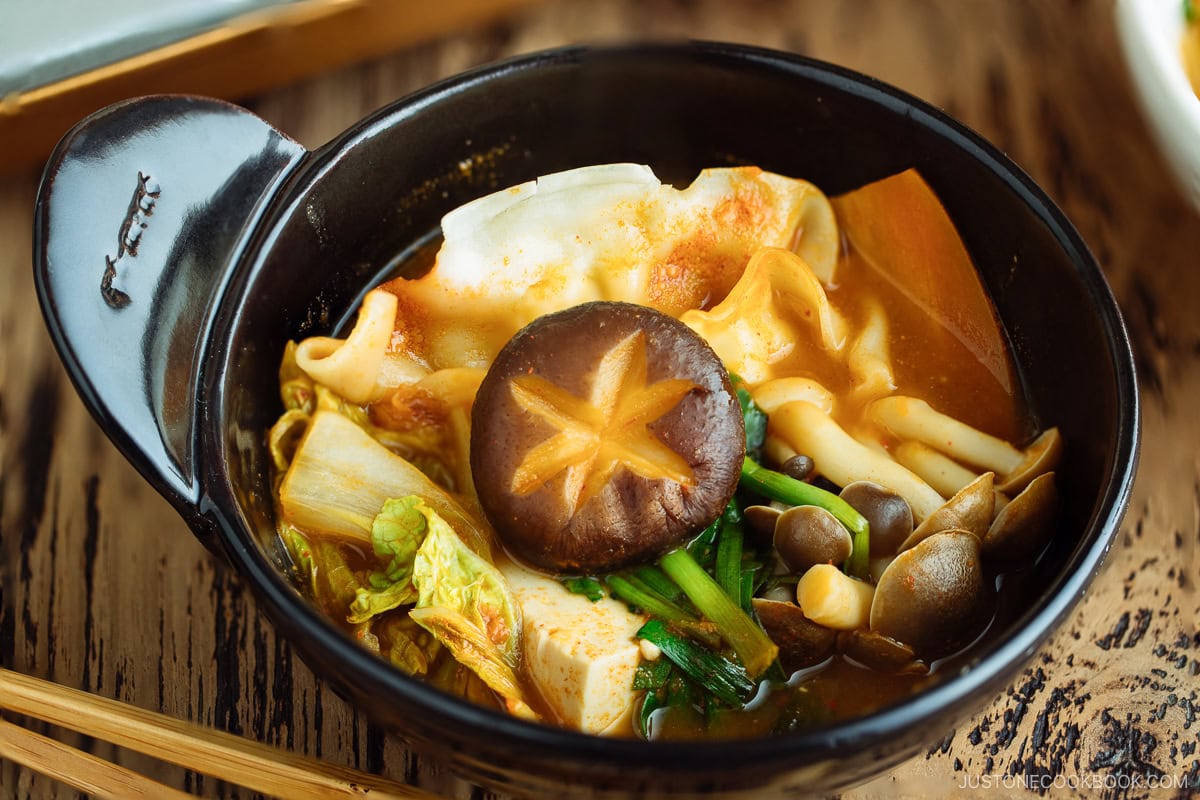 Kimchi Gyoza Nabe is served in a black ceramic bowl.