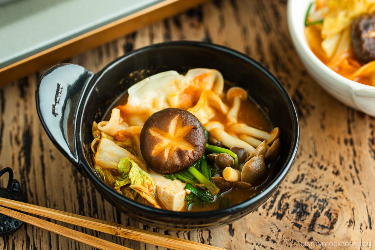 Kimchi Gyoza Nabe is served in a black ceramic bowl.