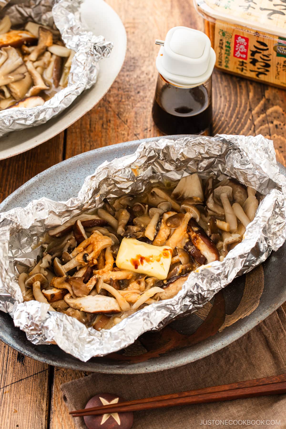 Assortment of mushrooms are wrapped and cooked in foil with miso and butter.