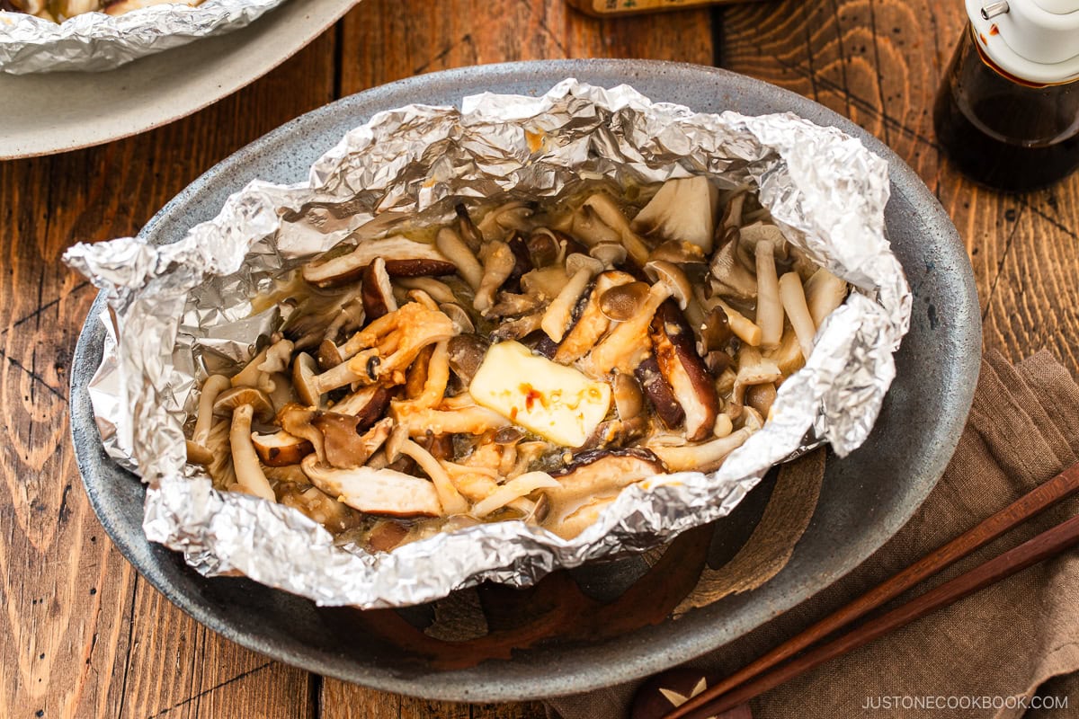 Assortment of mushrooms are wrapped and cooked in foil with miso and butter.
